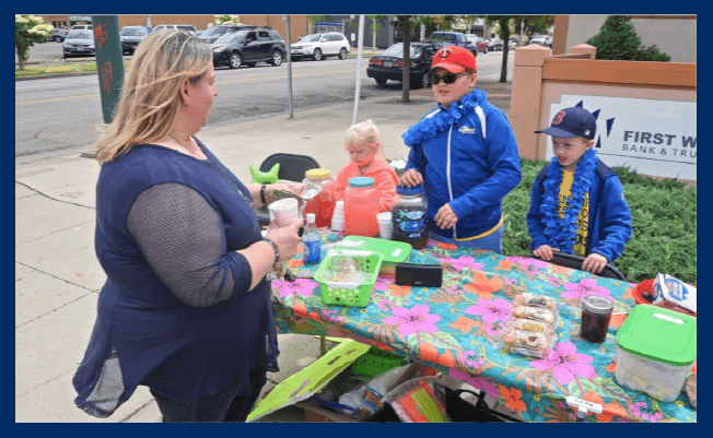 Customer buying lemonade from a lemonade stand.